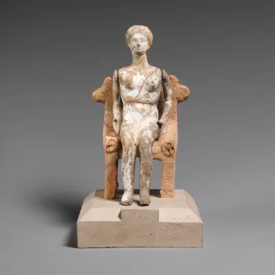 Terracotta figurine of a yound woman with articulated arms seated on a chair