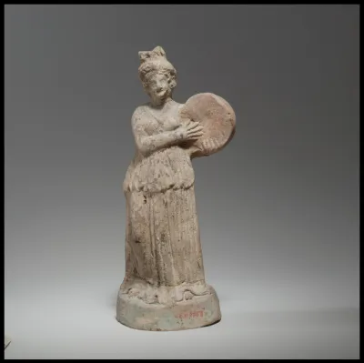 Terracotta statuette of woman playing a tympanon