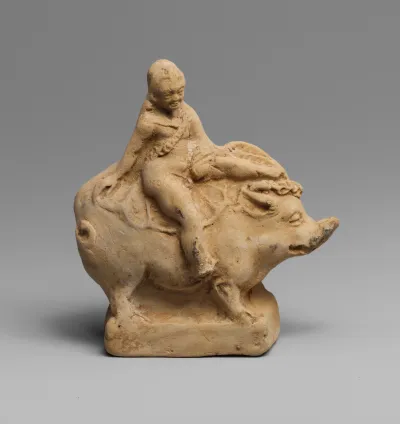 Terracotta statuette of Eros on a boar