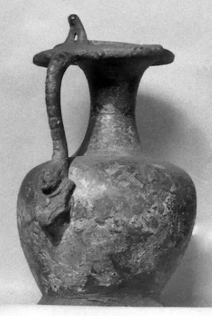 Römischer Bronzekrug [Komm.: (a.d.Bes.Bellori)] (Krug mit weiblicher Büste auf Henkelattasche)