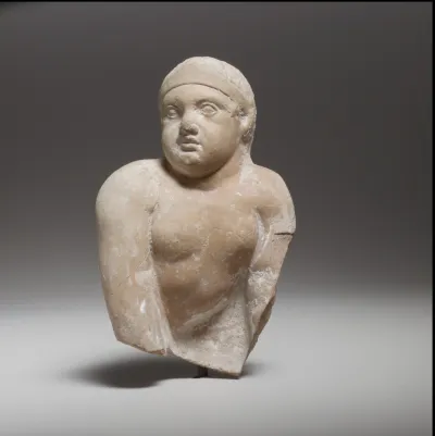 Terracotta statuette of a seated or crawling boy