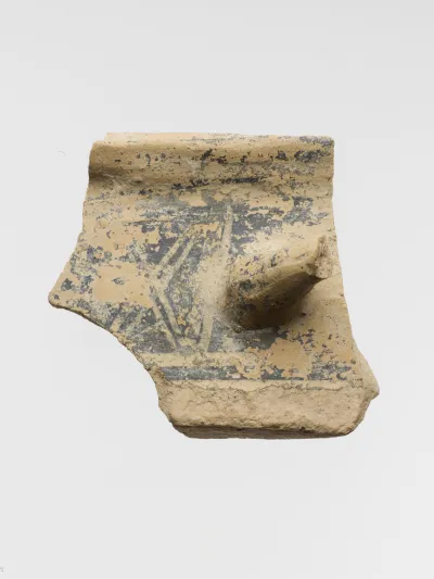 Terracotta fragment of a cylindrical pyxis (box with lid) with part of handle and hatched squares