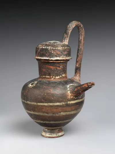 Terracotta spouted jug with high handle and slip lid