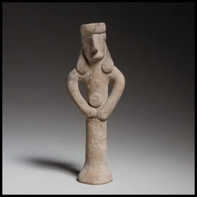 Standing figure holding a tambourine(?)