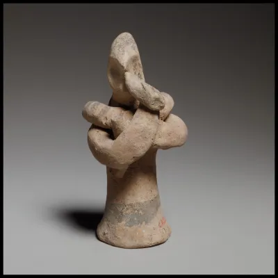 Standing male flute player with a serpent around his shoulders