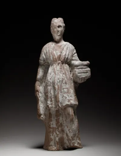 Terracotta figurine of a standing female votary holding a casket