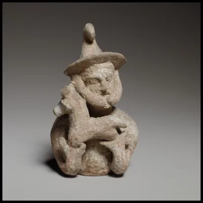 Terracotta statuette of a male votary offering a kid
