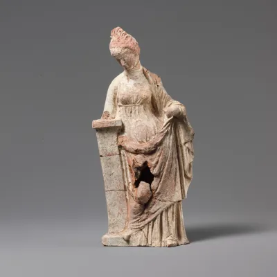 Terracotta statuette of a woman leaning on a pillar
