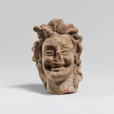 Terracotta head of a laughing satyr