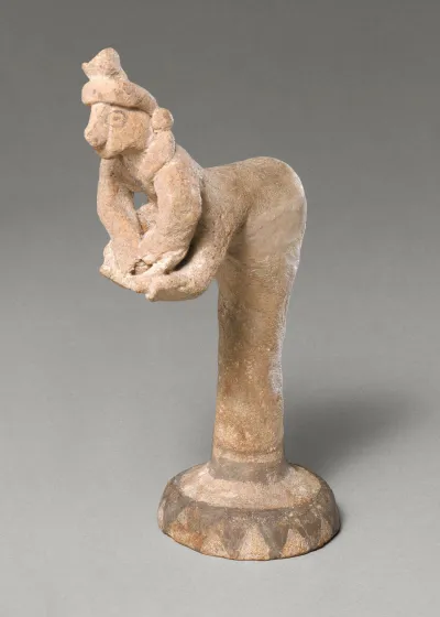 Female figurine kneading dough(?)