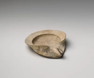 Terracotta saucer-shaped oil lamp