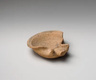 Terracotta saucer-shaped oil lamp