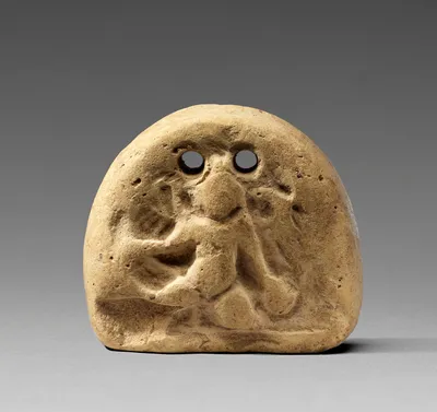 Loom weight with Kneeling Child (Herakles or Eros)