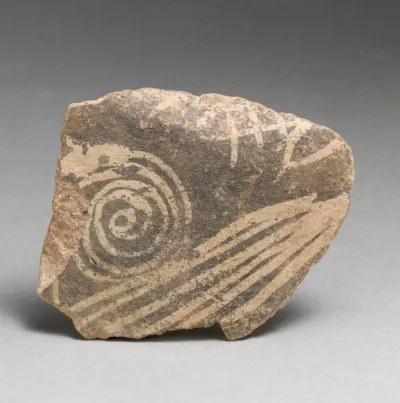Terracotta vessel fragment with spiral and linear motifs