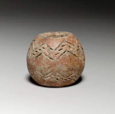 Spherical spindle-whorl with broad flat top and base