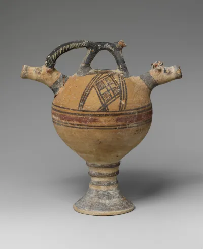 Terracotta vase on a high foot with two goats' heads in relief