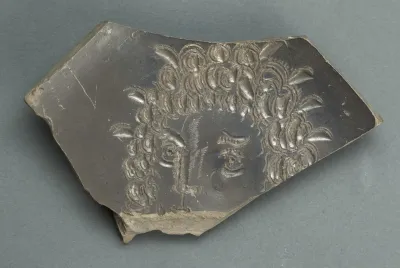 Plate with face, fragmentary