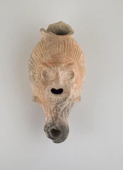 Terracotta lamp in the form of a grotesque head