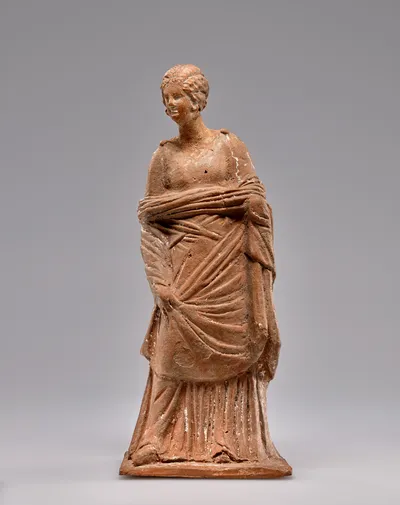 Terracotta Statuette of a Woman Raising a Cloak