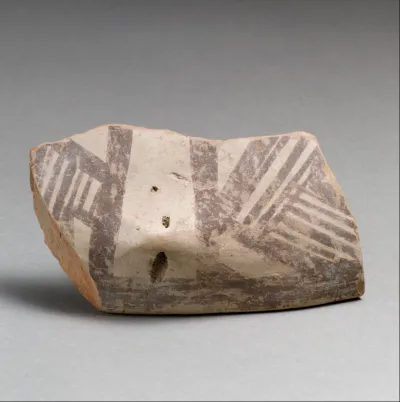 Terracotta rim fragment with lug and linear decoration