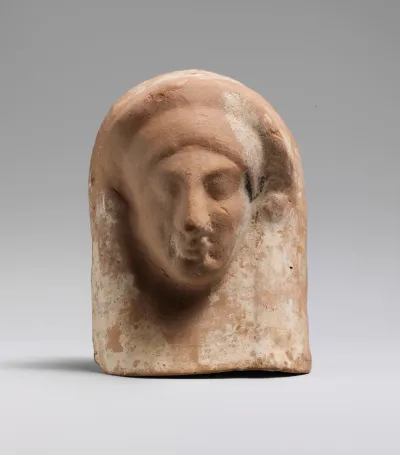 Terracotta relief with head of a woman
