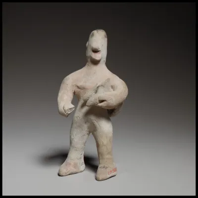 Standing male figurine holding a quadruped