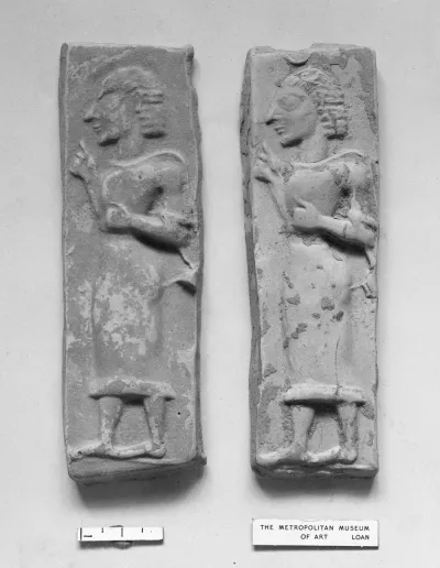 Terracotta plaque with a striding male figure