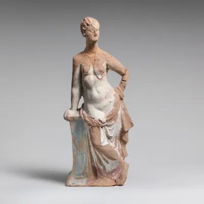 Terracotta statuette of a woman leaning on a pillar