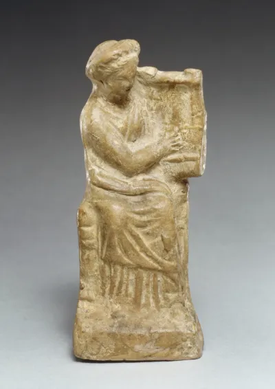 Terracotta statuette of a seated woman playing a kithera