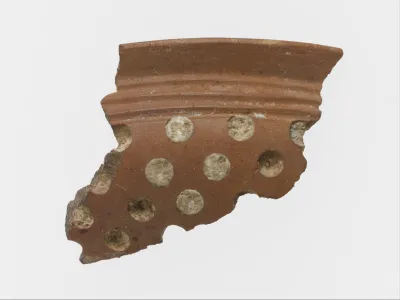 Terracotta rim fragment with white inlay