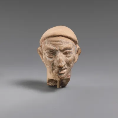 Terracotta head of a man wearing a cap