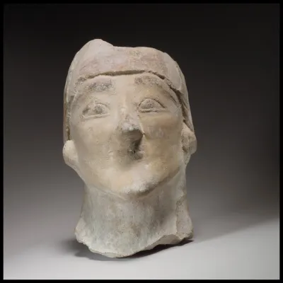 Beardless male head wearing a helmet