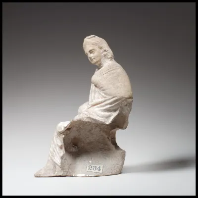 Terracotta statuette of a seated youth