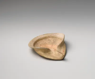 Terracotta saucer-shaped oil lamp