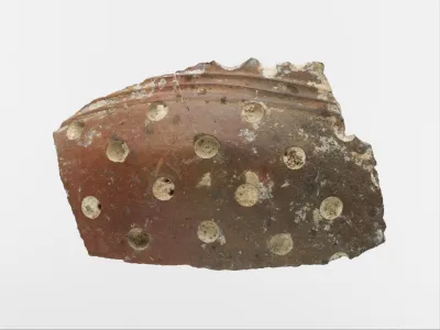 Terracotta vase fragment with white inlay