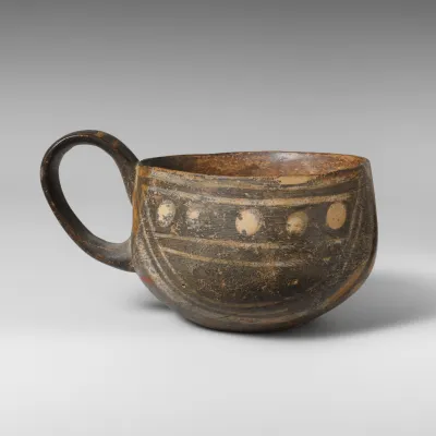 Terracotta one-handled cup, white-on-dark ware